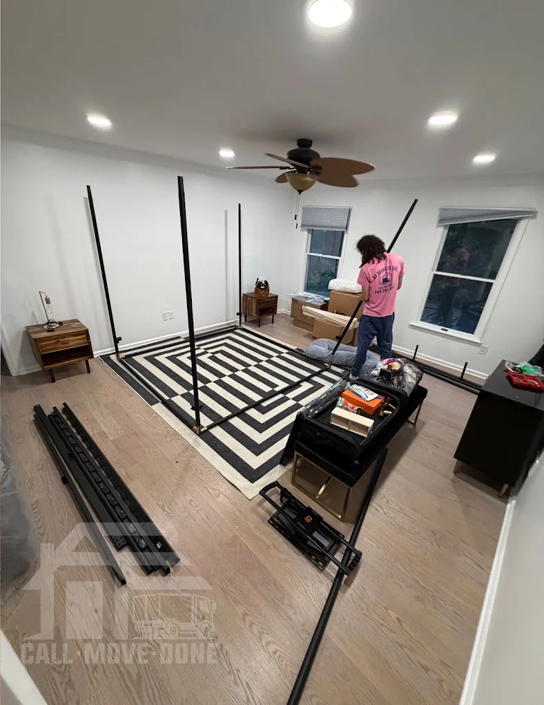 Mover reassembling a bed frame in the new home