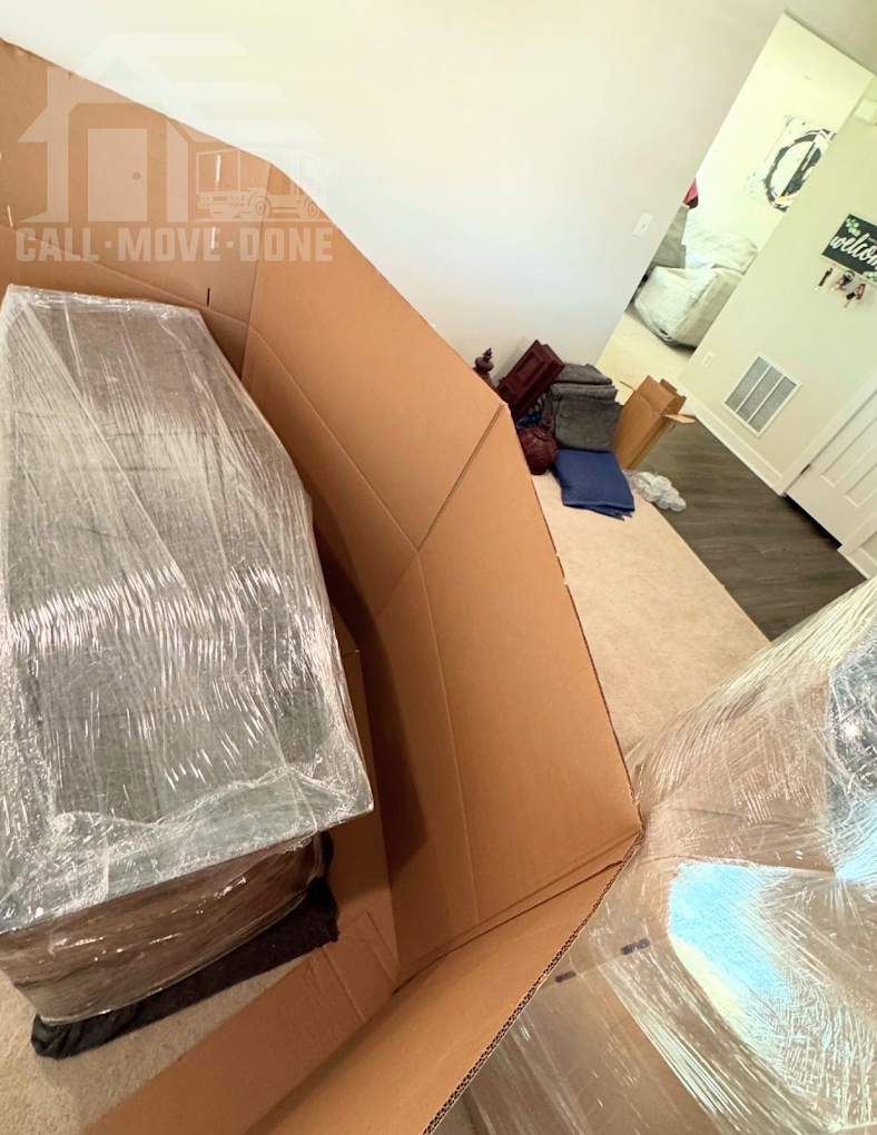 Wardrobe box and wrapped furniture staged in a hallway